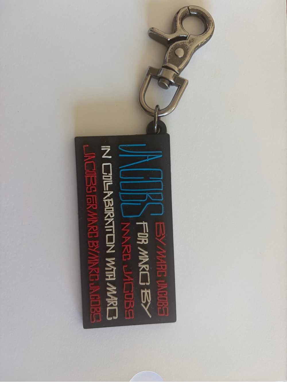 Marc Jacobs Black Rubber Logo Tag with Blue & Red Lettering